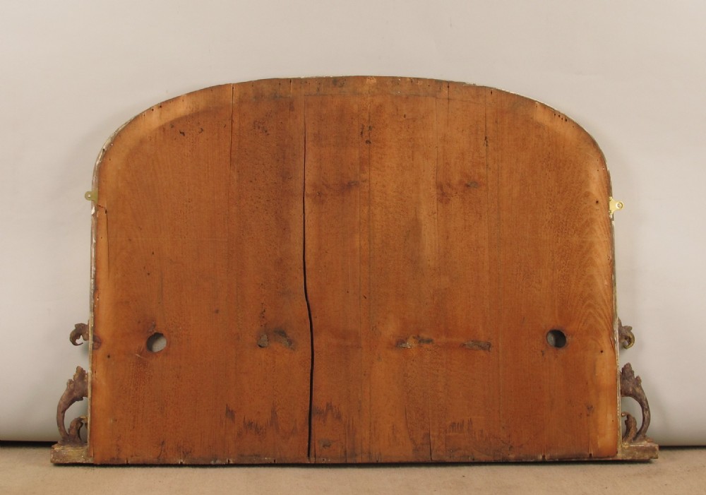 An arched Victorian overmantel mirror featuring a gilded frame with beaded moulding and scrollwork side supports. View VIII