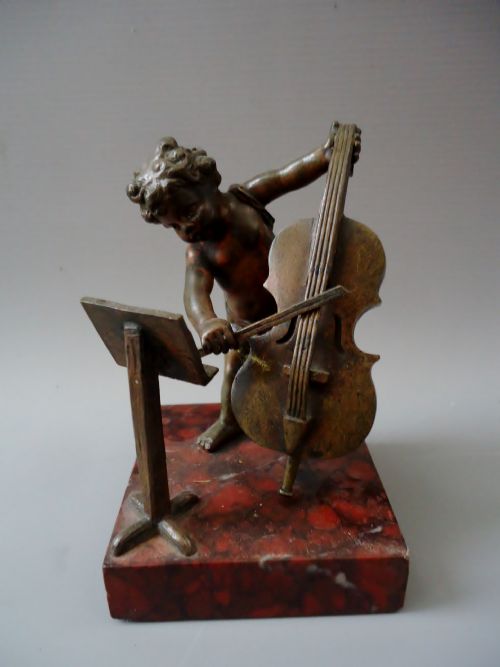 A Small Bronze of a Cherub Musician