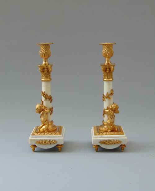 A Fine Pair of Carrara Marble and Ormolu Cherub Candlesticks