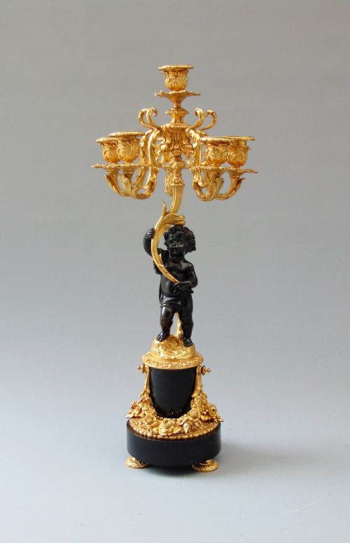 A Bronze Cherub Candlestick