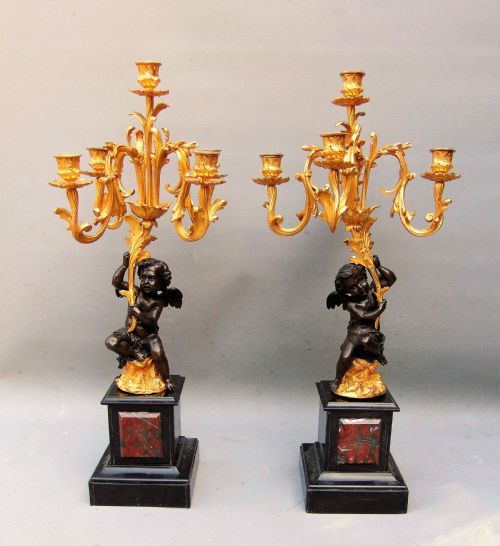 A Large Pair of Bronze Gilt Cherub Candelabra