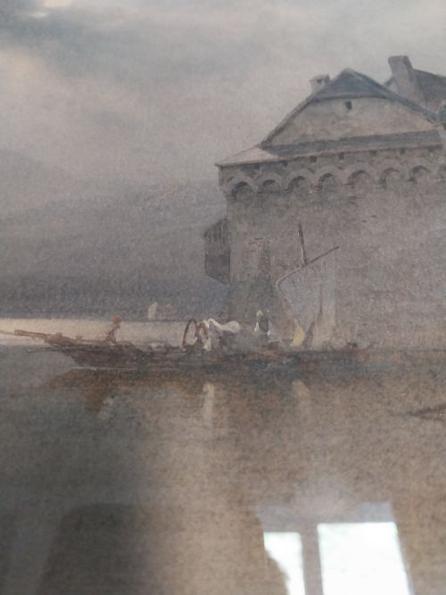 fig 4. A framed 19th-century watercolour painting depicting Chillon Castle on Lake Geneva under an atmospheric sky with figures in boats in the foreground.