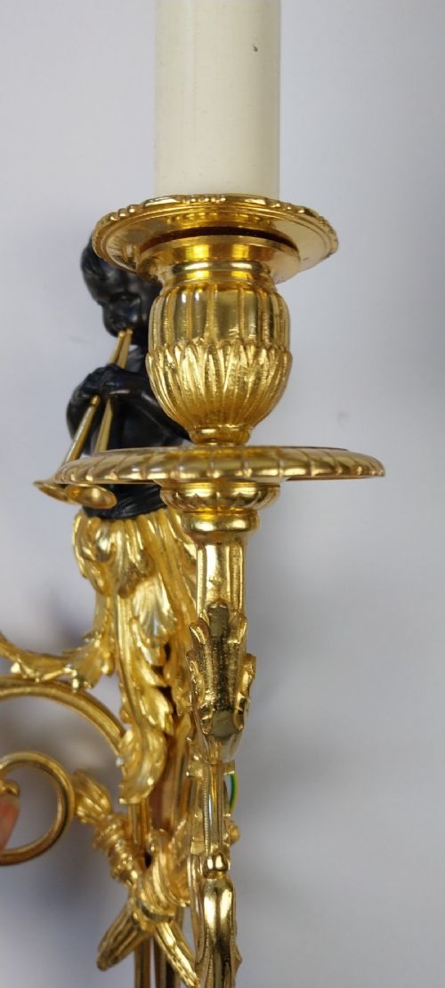 A pair of French gilt and dark patinated bronze two-branch wall sconces featuring central figures holding musical instruments. View VII