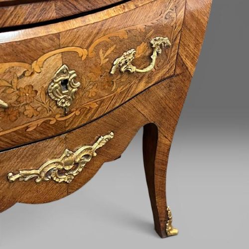 A French Louis XV style bombe commode featuring floral marquetry inlays, gilt bronze mounts, two drawers, cabriole legs, and a red marble top. View II