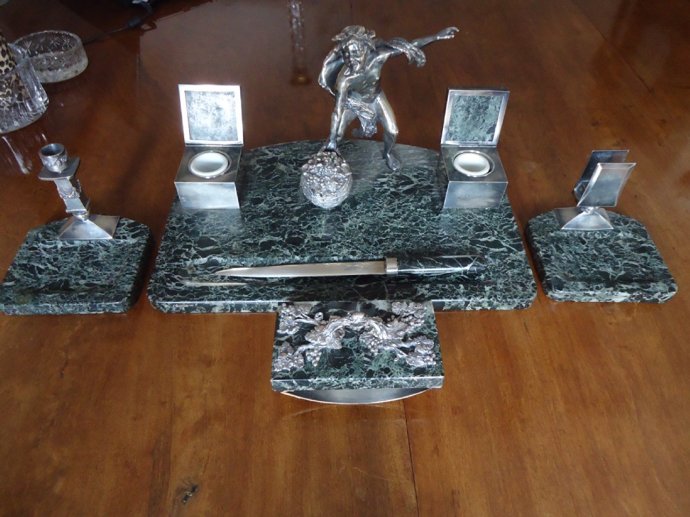 A silver plate and marble desk set