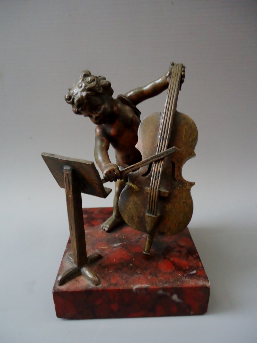 A small bronze of a cherub musician