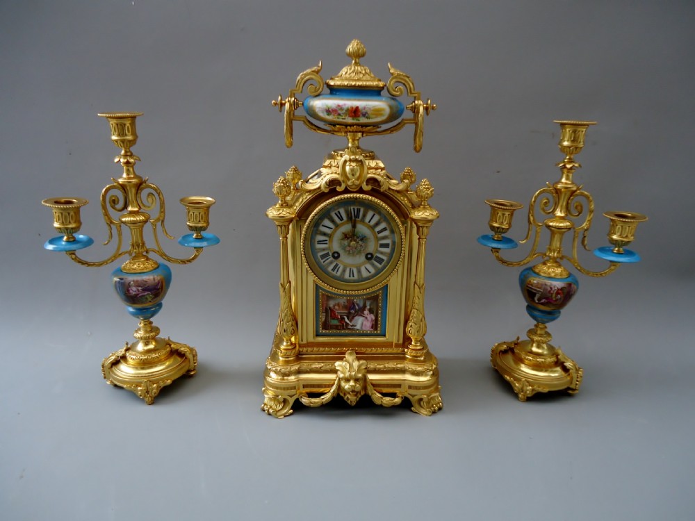 A Ormolu clock set with sevres style porcelain panels 