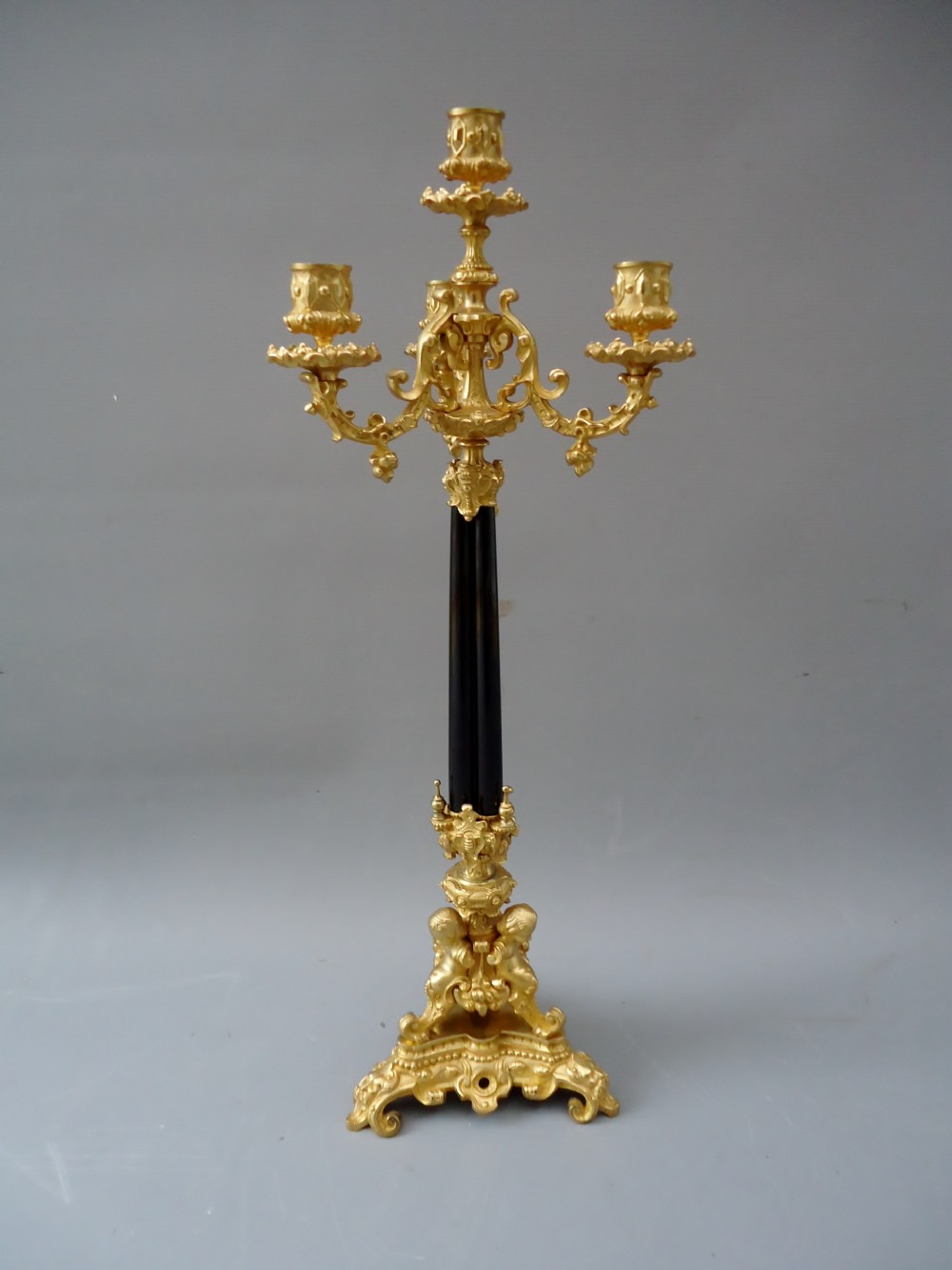 A high quality antique french ormolu and ebony candle stick 