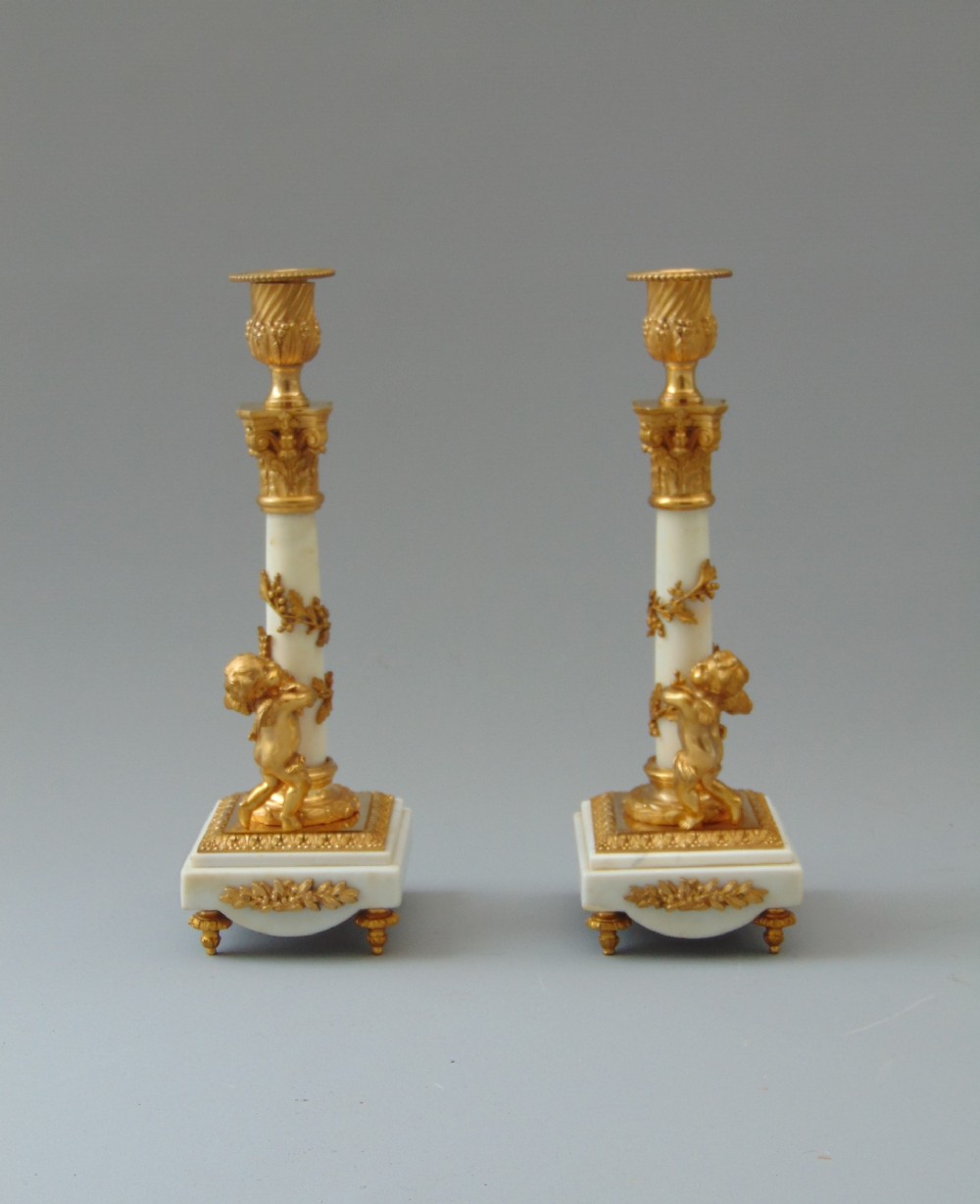 A fine Pair of Carrara Marble and Ormolu Cherub Candlesticks 