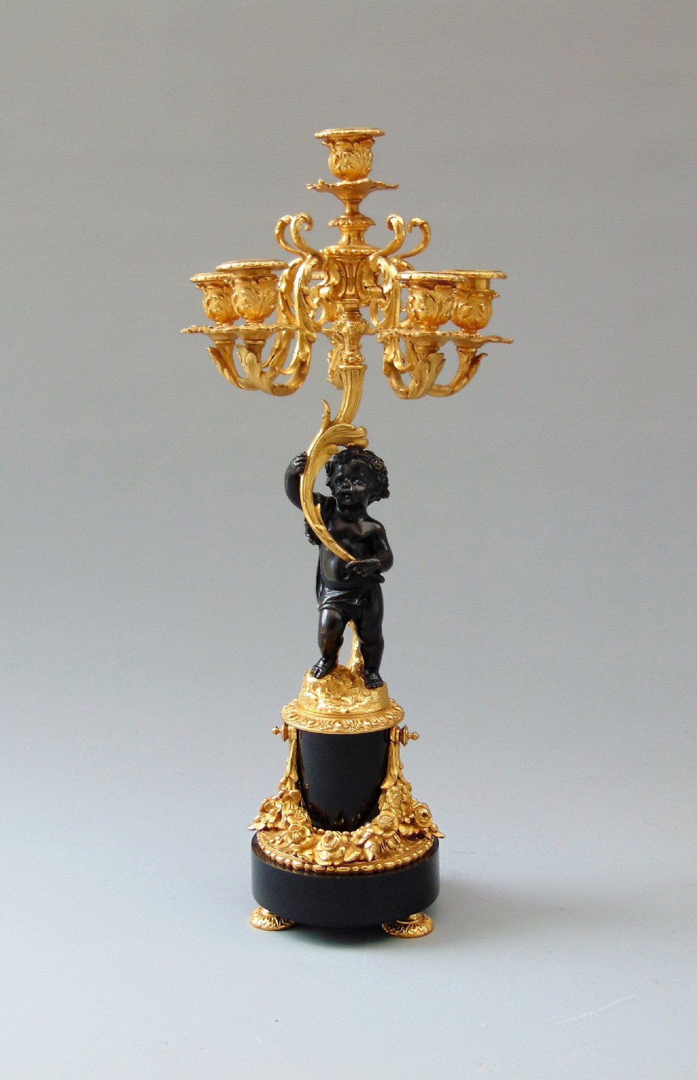 A Bronze cherub Candlestick 