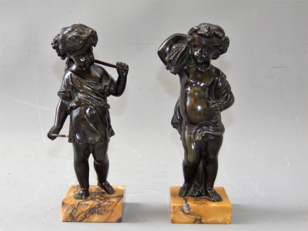 A pair of bronze cherubs 