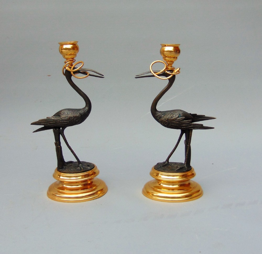 A pair of stork candlesticks 