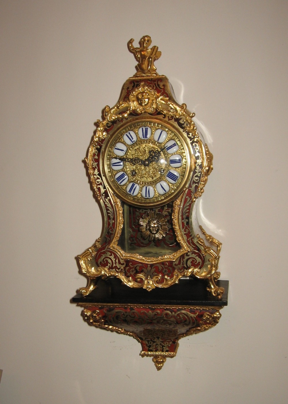 Antique red boulle clock and bracket