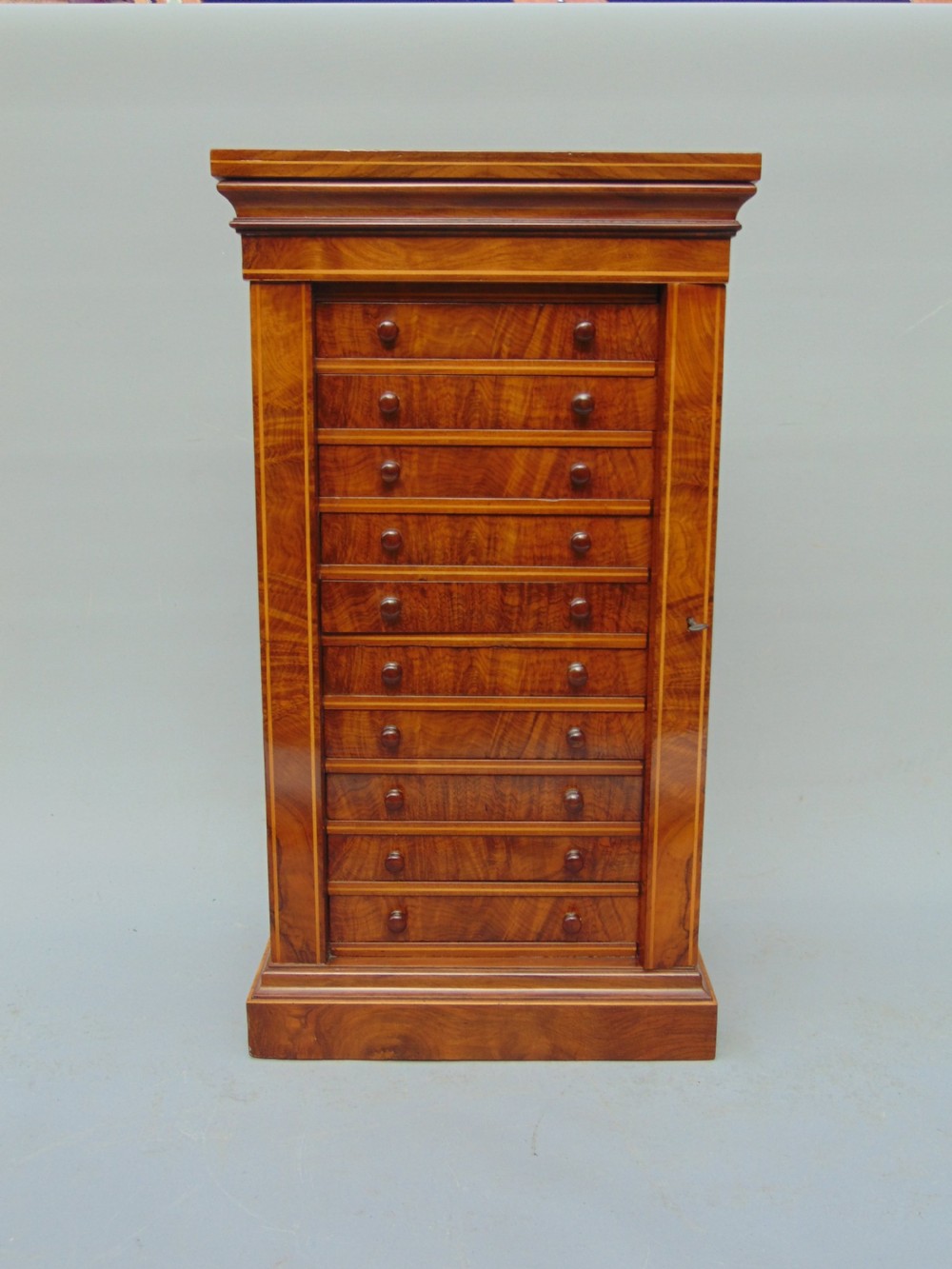 A rare miniature walnut wellington collectors chest 