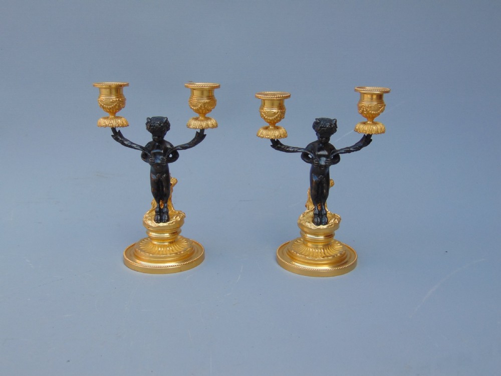 A pretty pair of cherub Candlesticks 