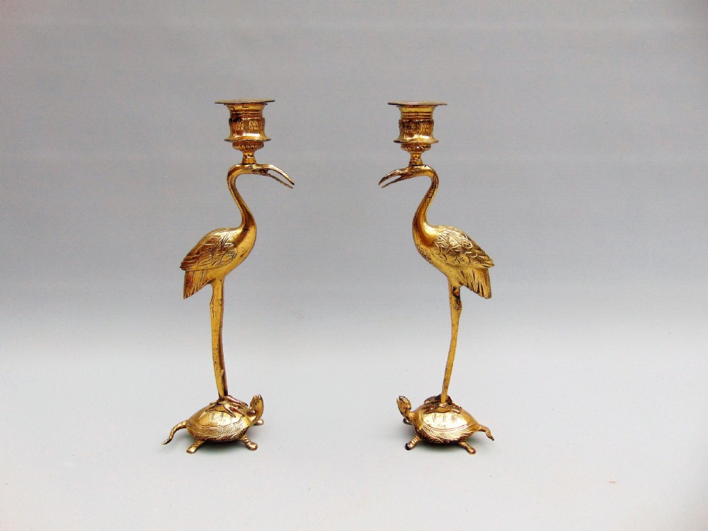 A pair of stork candlesticks 
