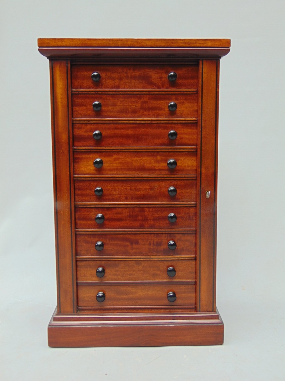 A quality Mahogany miniature wellington chest collectors cabinet