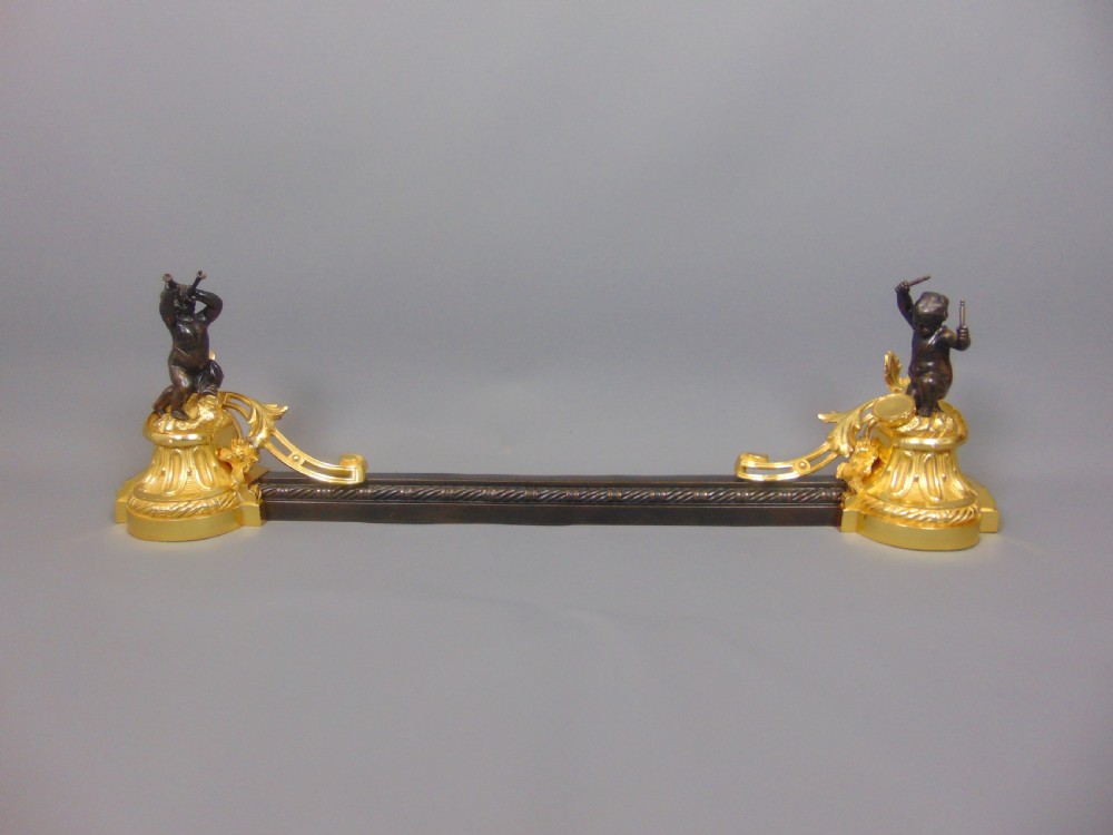 A Gilt and Bronze Cherub Chenet Fender 