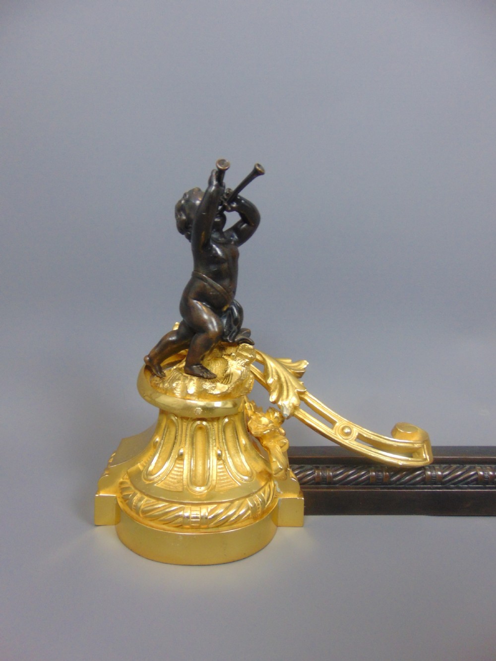 A Gilt and Bronze Cherub Chenet Fender  View II