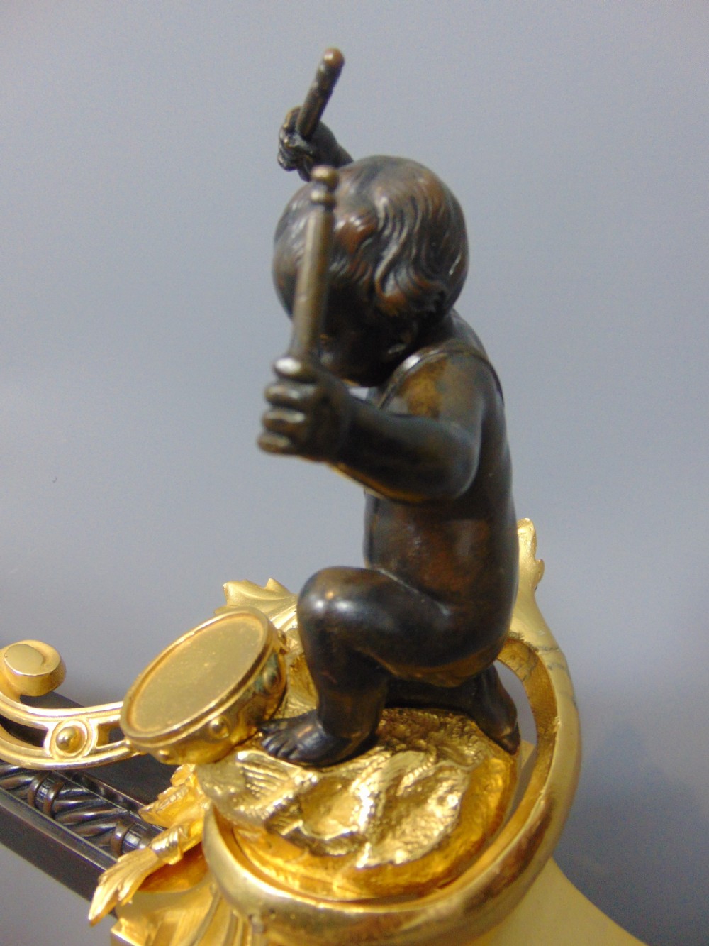 A Gilt and Bronze Cherub Chenet Fender  View V