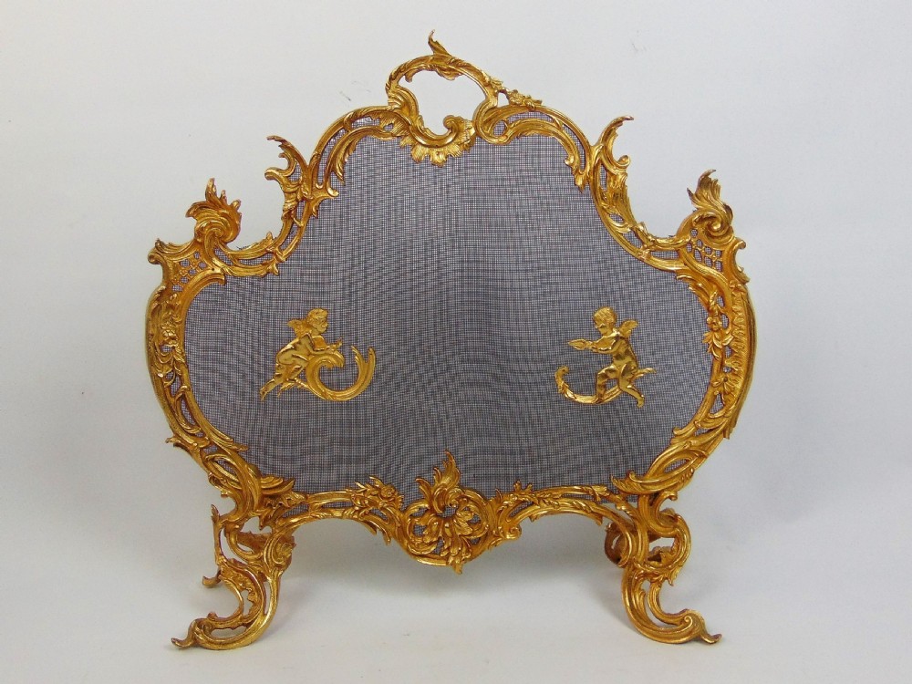 A superb gilt cherub fire screen 