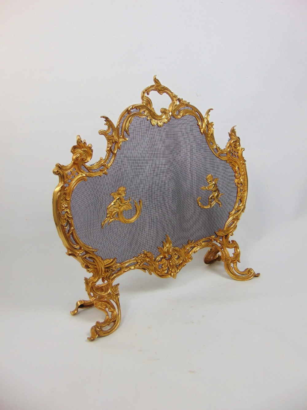 A superb gilt cherub fire screen  View II