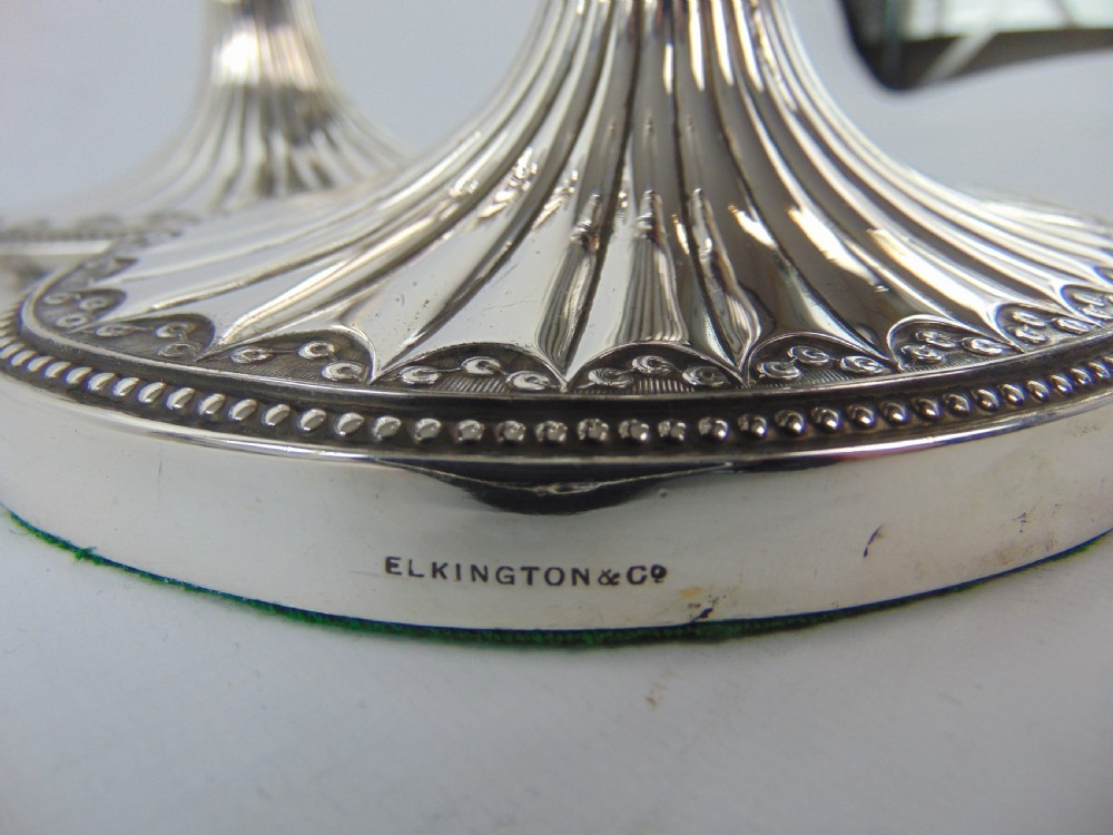 a FINE PAIR OF ELKINGTON SILVER CANDLESTICKS  View VI