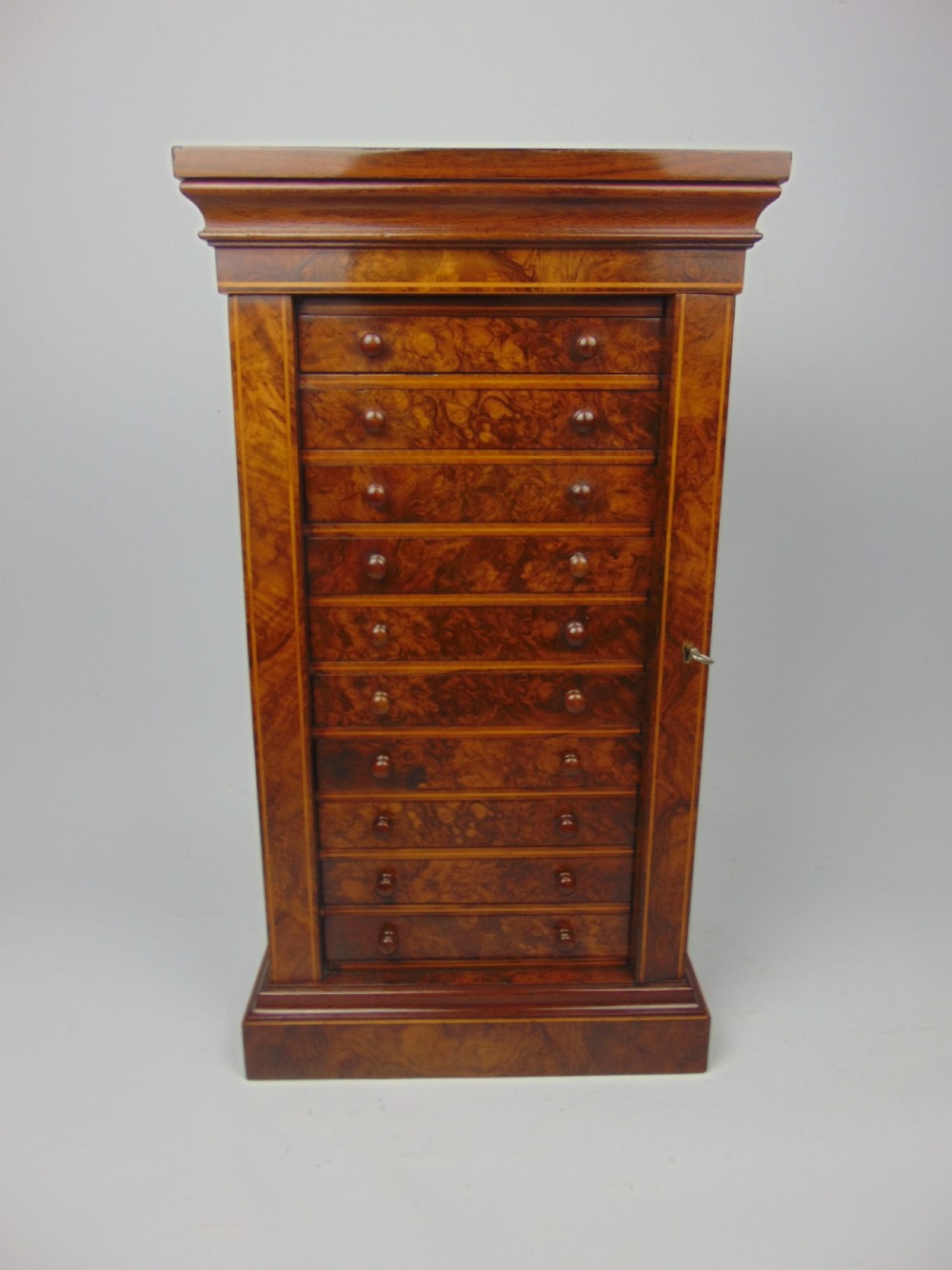 A rare miniature walnut wellington chest View II