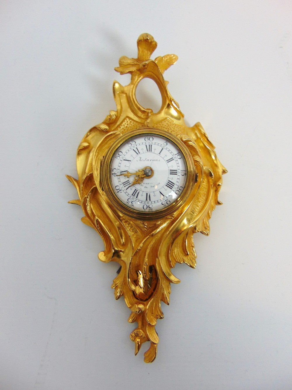A gilt bronze cartel clock