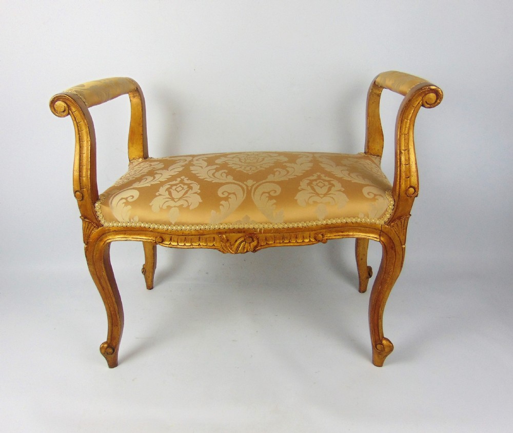 A pretty giltwood window seat