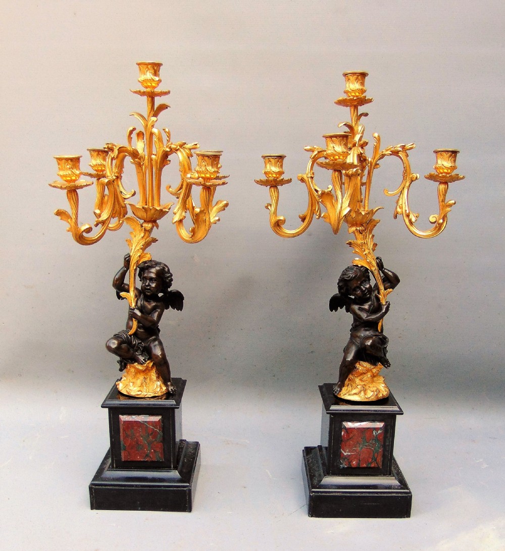 A large pair of bronze gilt cherub candelabra 