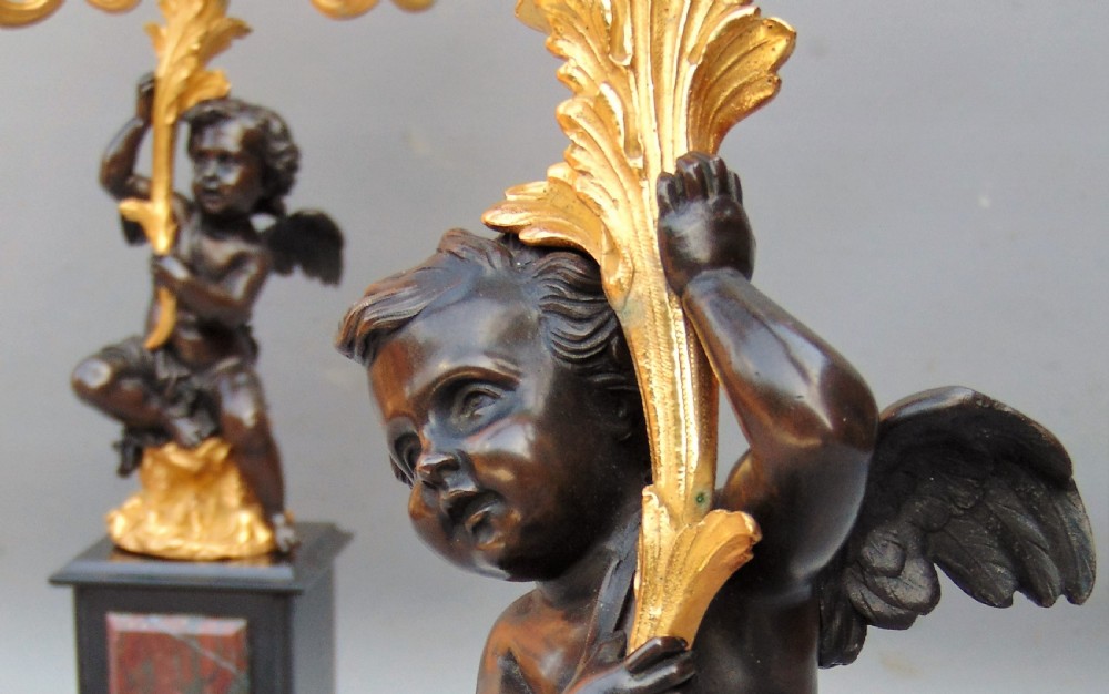 A large pair of bronze gilt cherub candelabra  View II