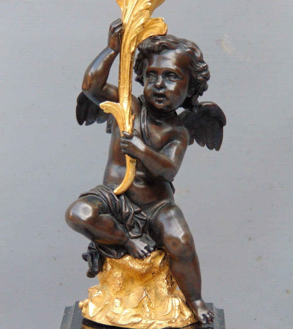 A large pair of bronze gilt cherub candelabra  View III