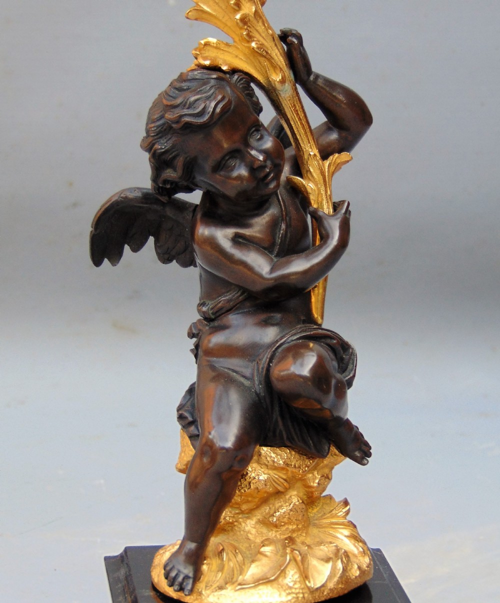 A large pair of bronze gilt cherub candelabra  View V