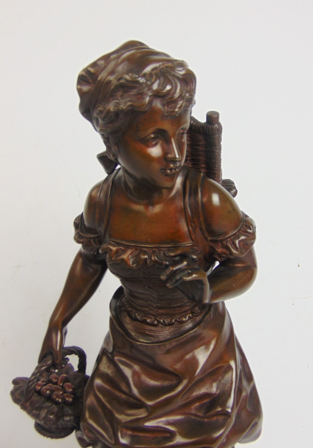 A large bronze bare footed girl collecting eggs View VI