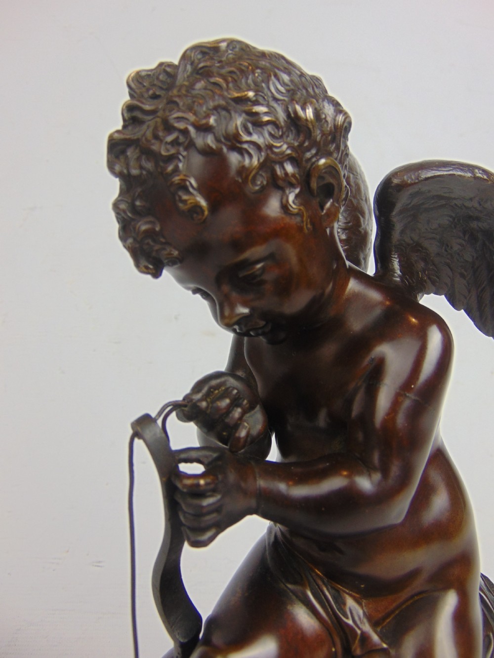 A Bronze Cupid stringing his bow  View II