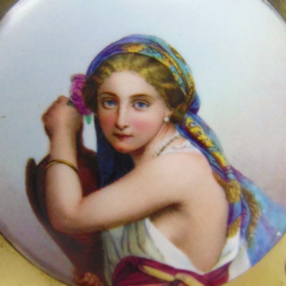 An antique burr walnut book slide featuring pierced brass strapwork with cut-out motifs and two inset circular porcelain plaques painted with female portraits. View III