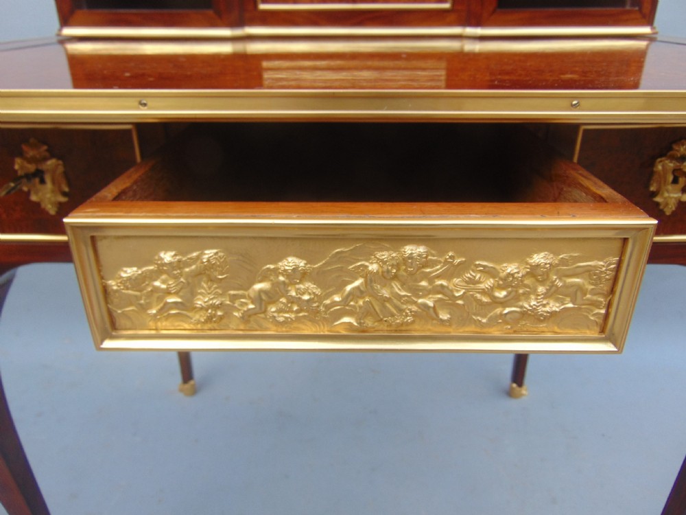 A nineteenth-century French writing desk featuring burr wood veneers, gilt bronze mounts, cabriole legs, and a raised superstructure with small drawers. View VII