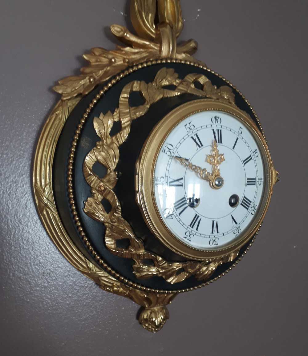 A Gilt and Bronze Cartel Ribbon Clock View V