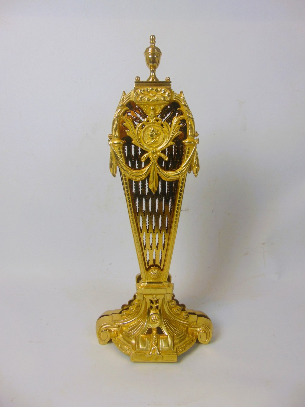 An antique French gilt bronze folding fan fire screen featuring intricate pierced lattice panels, a central crest with a relief medallion, and a weighted cast scroll base. View II