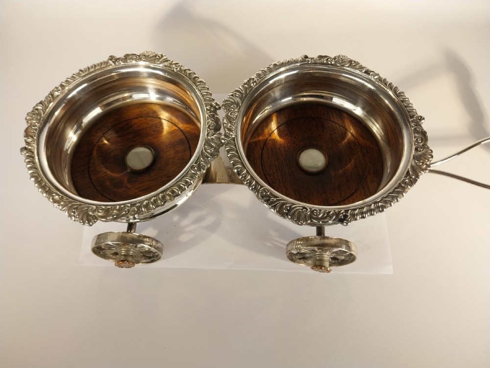 Victorian silver-plated double wine bottle trolley featuring two gadrooned coasters mounted on a wheeled frame with a long handle. View II