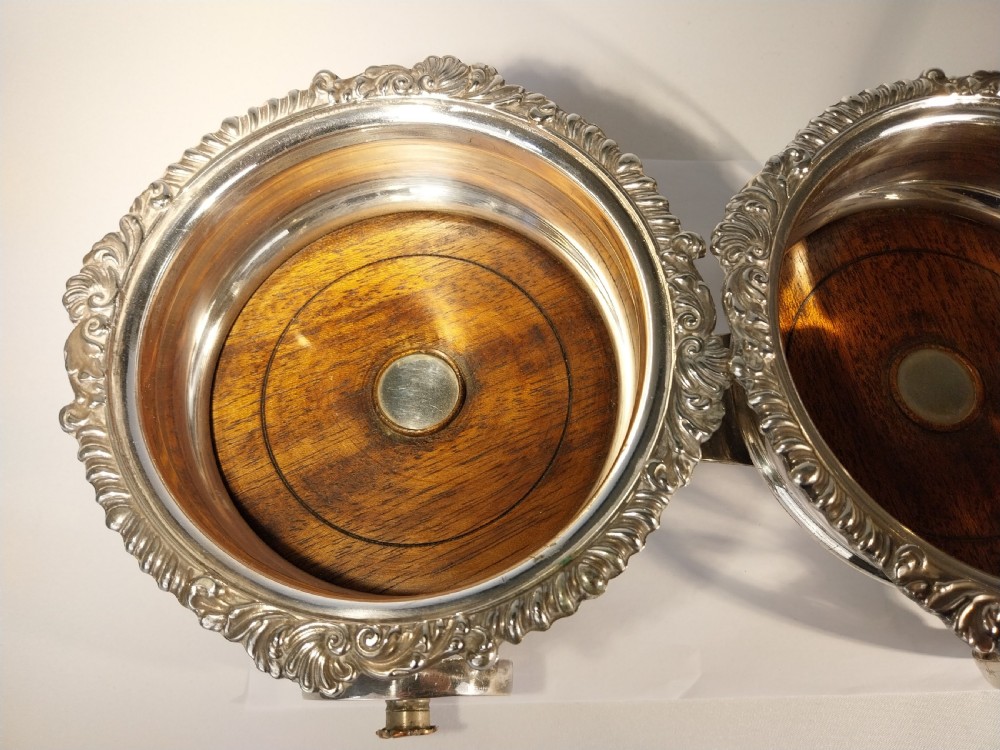 Victorian silver-plated double wine bottle trolley featuring two gadrooned coasters mounted on a wheeled frame with a long handle. View V