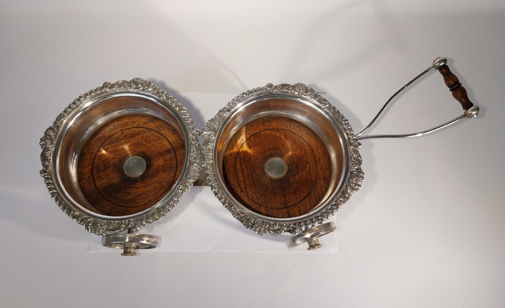 Victorian silver-plated double wine bottle trolley featuring two gadrooned coasters mounted on a wheeled frame with a long handle. View VI