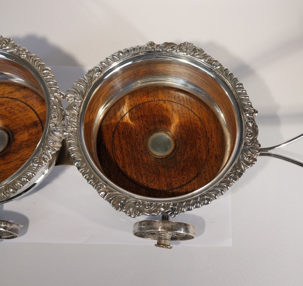 Victorian silver-plated double wine bottle trolley featuring two gadrooned coasters mounted on a wheeled frame with a long handle. View XII