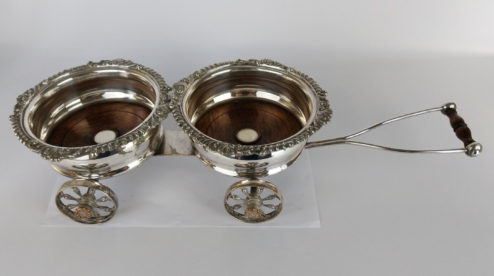 Victorian silver-plated double wine bottle trolley featuring two gadrooned coasters mounted on a wheeled frame with a long handle. View XV