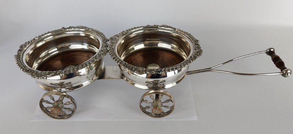 Victorian silver-plated double wine bottle trolley featuring two gadrooned coasters mounted on a wheeled frame with a long handle. View XVI