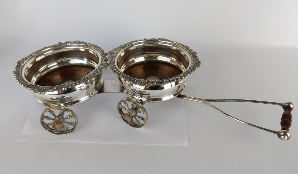 Victorian silver-plated double wine bottle trolley featuring two gadrooned coasters mounted on a wheeled frame with a long handle. View XVIII