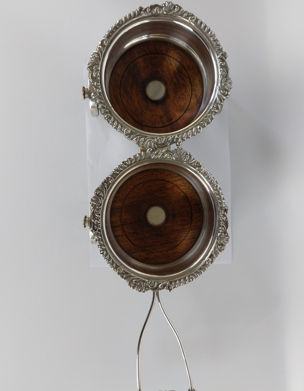 Victorian silver-plated double wine bottle trolley featuring two gadrooned coasters mounted on a wheeled frame with a long handle. View XXII