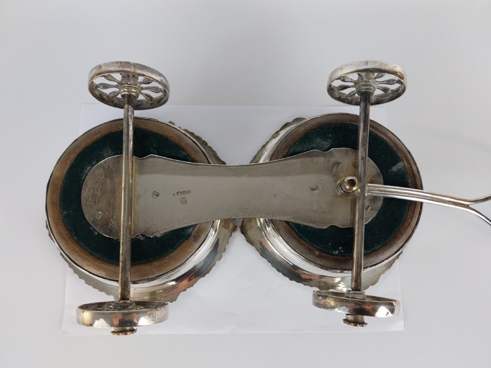Victorian silver-plated double wine bottle trolley featuring two gadrooned coasters mounted on a wheeled frame with a long handle. View XXVII