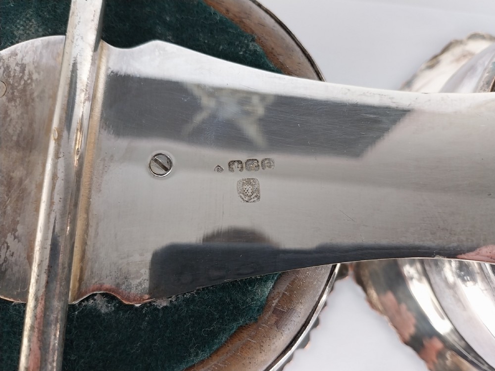 Victorian silver-plated double wine bottle trolley featuring two gadrooned coasters mounted on a wheeled frame with a long handle. View XXVIII
